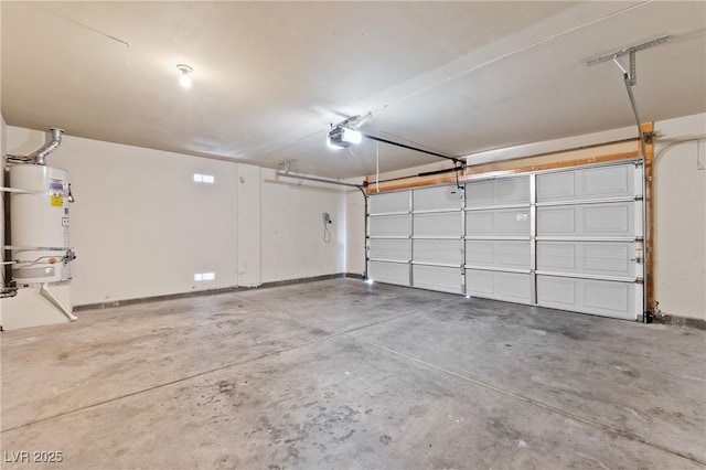 5307 Wild Orchid St, North Las Vegas, NV 89031 - garage featuring strapped water heater, a garage door opener, and baseboards