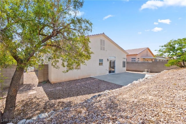 5307 Wild Orchid St, North Las Vegas, NV 89031 - back of house featuring stucco siding, a patio, a fenced backyard, and a tile roof