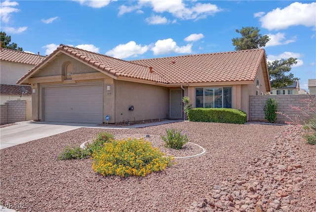 1219 Heather Oaks Way N, Las Vegas, NV 89031 - view of front of house with a garage, driveway, stucco siding, and a tile roof