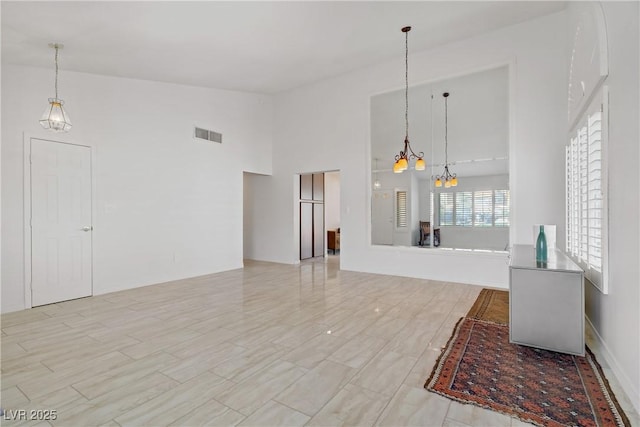 1219 Heather Oaks Way N, Las Vegas, NV 89031 - unfurnished living room featuring a chandelier and high vaulted ceiling