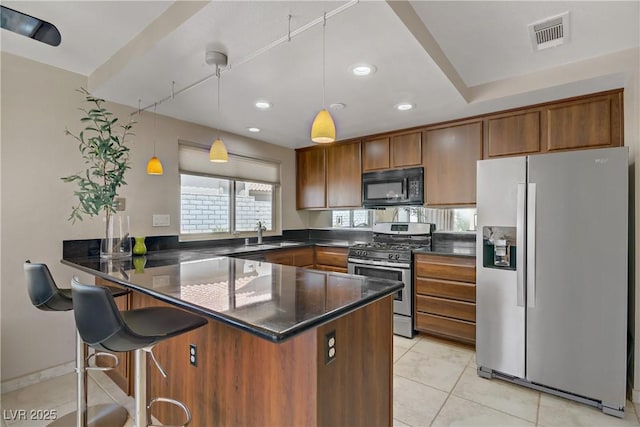 1219 Heather Oaks Way N, Las Vegas, NV 89031 - kitchen with appliances with stainless steel finishes, dark countertops, a peninsula, recessed lighting, and light tile patterned floors
