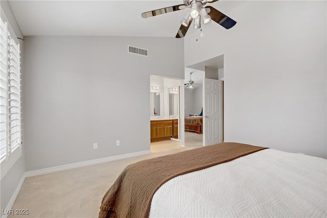 1219 Heather Oaks Way N, Las Vegas, NV 89031 - bedroom featuring light carpet, high vaulted ceiling, multiple windows, baseboards, and connected bathroom