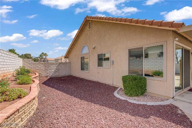1219 Heather Oaks Way N, Las Vegas, NV 89031 - view of side of home featuring a fenced backyard and stucco siding
