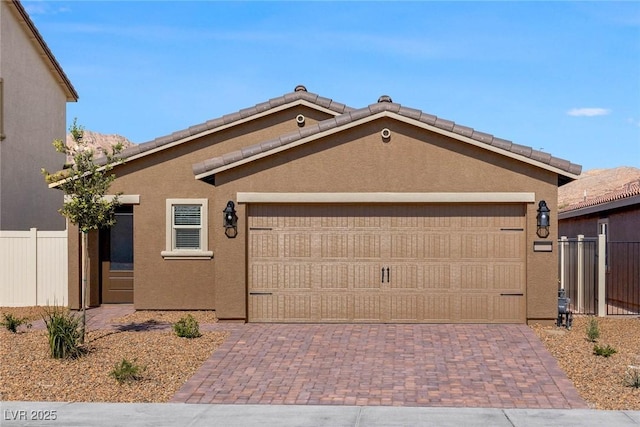 1716 Desert Path Ave, North Las Vegas, NV 89032 - view of front of property with decorative driveway, an attached garage, and stucco siding