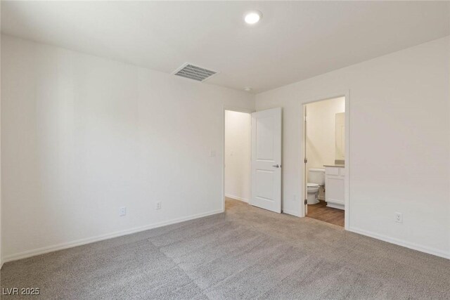 1716 Desert Path Ave, North Las Vegas, NV 89032 - unfurnished bedroom with carpet flooring, baseboards, connected bathroom, and recessed lighting