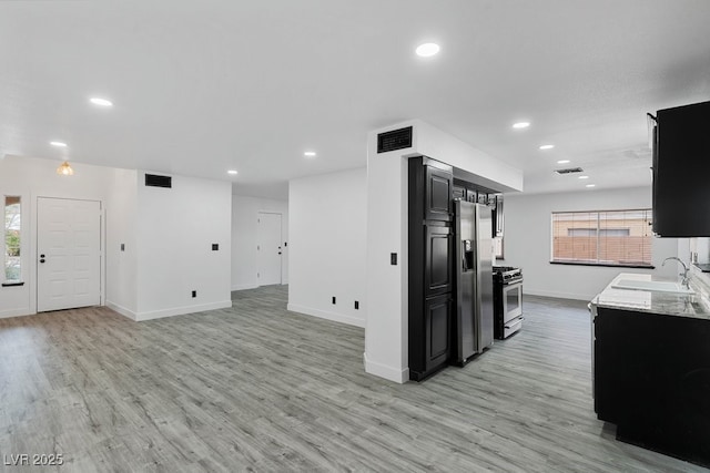 3217 Harbor Vista St, Las Vegas, NV 89117 - kitchen featuring appliances with stainless steel finishes, dark cabinetry, baseboards, a sink, and healthy amount of natural light