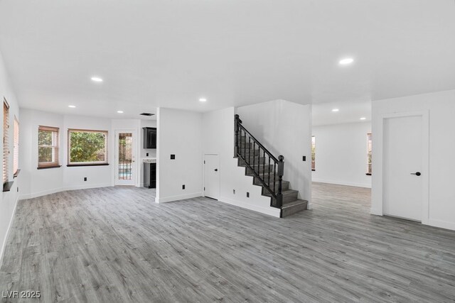 3217 Harbor Vista St, Las Vegas, NV 89117 - unfurnished living room with light wood finished floors, recessed lighting, stairway, and baseboards