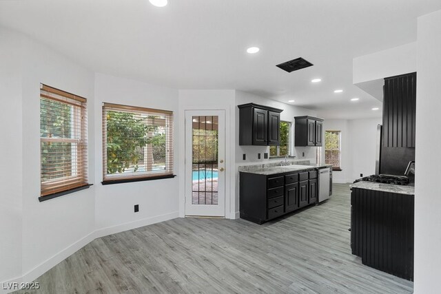 3217 Harbor Vista St, Las Vegas, NV 89117 - kitchen with dark cabinets, light wood-style flooring, baseboards, and recessed lighting
