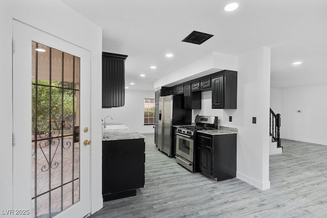 3217 Harbor Vista St, Las Vegas, NV 89117 - kitchen featuring gas range, dark cabinetry, a sink, light wood-style floors, and recessed lighting