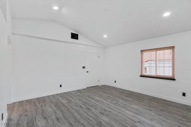 3217 Harbor Vista St, Las Vegas, NV 89117 - empty room with lofted ceiling, recessed lighting, wood finished floors, and baseboards