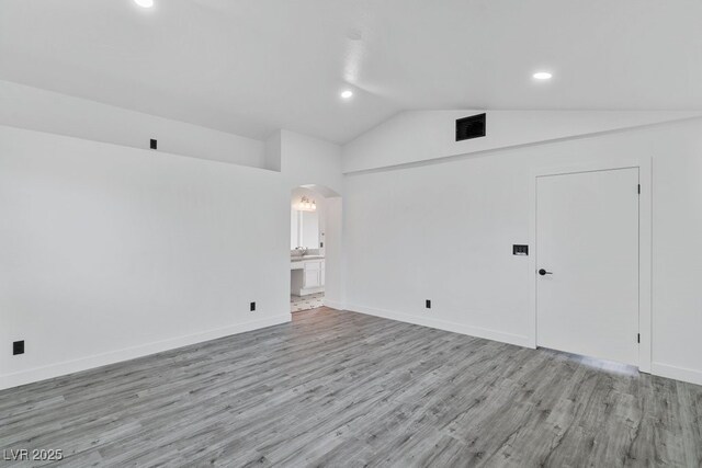 3217 Harbor Vista St, Las Vegas, NV 89117 - spare room featuring arched walkways, lofted ceiling, light wood finished floors, recessed lighting, and baseboards