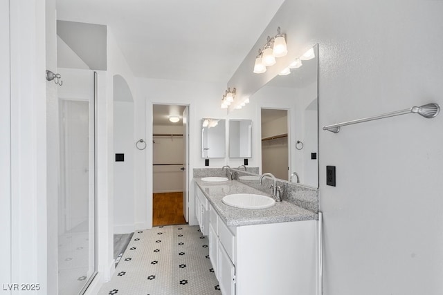 3217 Harbor Vista St, Las Vegas, NV 89117 - full bathroom featuring a spacious closet, a stall shower, double vanity, and tile patterned floors