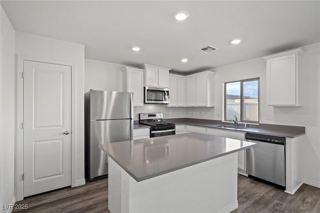 1705 Desert Path Ave, North Las Vegas, NV 89032 - kitchen featuring stainless steel appliances, a sink, dark wood finished floors, white cabinets, and recessed lighting