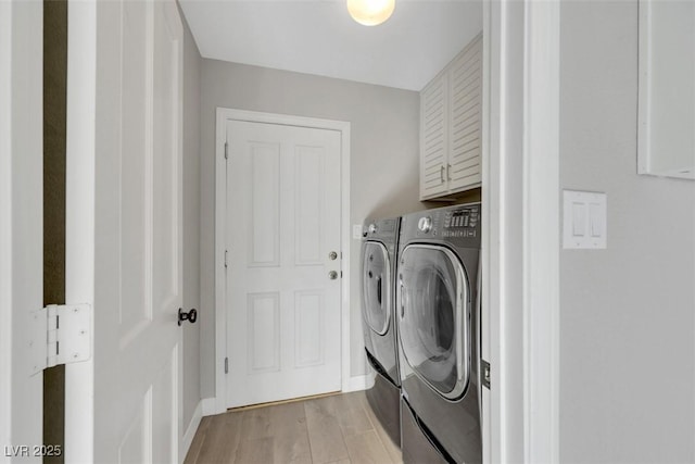 5008 Shoal Creek Cir, Las Vegas, NV 89113 - laundry area featuring separate washer and dryer, cabinet space, light wood-style floors, and baseboards