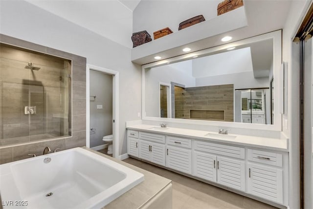5008 Shoal Creek Cir, Las Vegas, NV 89113 - bathroom with toilet, a tub to relax in, double vanity, tiled shower, and tile patterned flooring