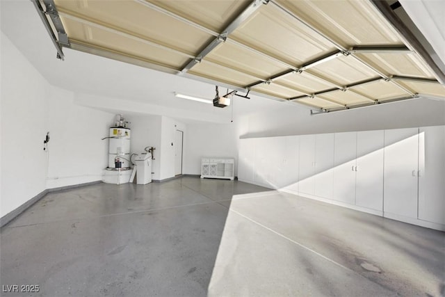 5008 Shoal Creek Cir, Las Vegas, NV 89113 - garage featuring strapped water heater, baseboards, and a garage door opener