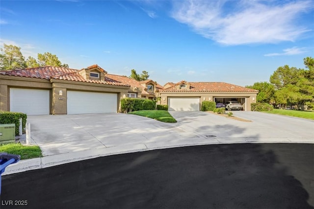 5008 Shoal Creek Cir, Las Vegas, NV 89113 - mediterranean / spanish-style home featuring concrete driveway, an attached garage, stucco siding, and a tiled roof