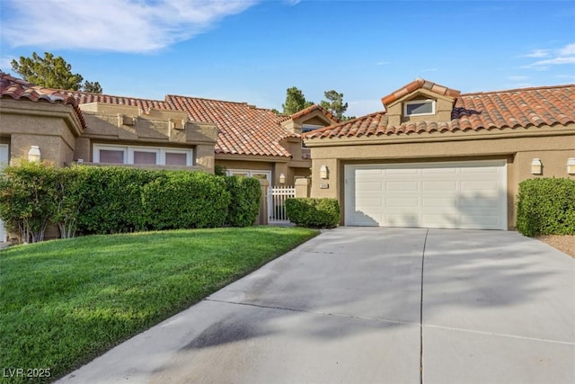 5008 Shoal Creek Cir, Las Vegas, NV 89113 - mediterranean / spanish house with concrete driveway, stucco siding, a front yard, an attached garage, and a tiled roof