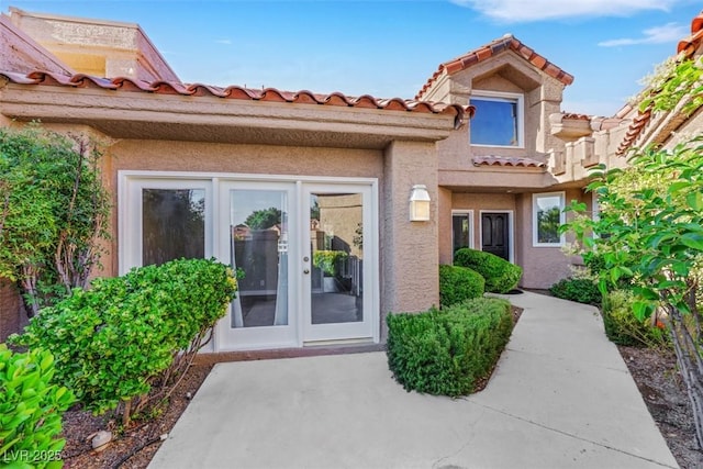 5008 Shoal Creek Cir, Las Vegas, NV 89113 - view of exterior entry with a tile roof and stucco siding