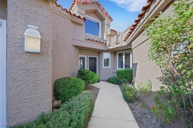5008 Shoal Creek Cir, Las Vegas, NV 89113 - doorway to property with a tiled roof and stucco siding