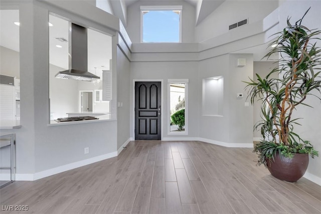 5008 Shoal Creek Cir, Las Vegas, NV 89113 - foyer entrance with healthy amount of natural light, wood finished floors, baseboards, and a towering ceiling