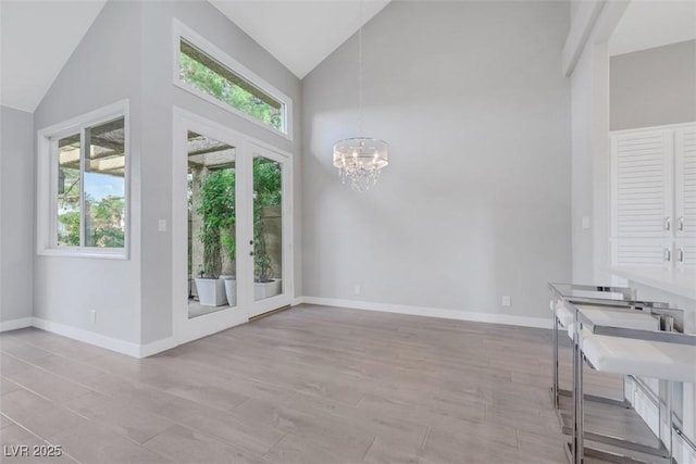 5008 Shoal Creek Cir, Las Vegas, NV 89113 - foyer with plenty of natural light, high vaulted ceiling, a chandelier, and baseboards