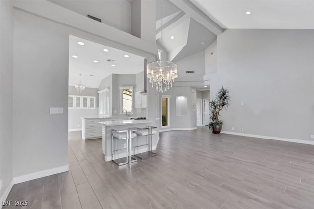 5008 Shoal Creek Cir, Las Vegas, NV 89113 - living room with a chandelier, high vaulted ceiling, baseboards, wood finished floors, and recessed lighting