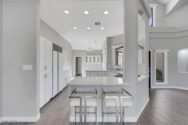 5008 Shoal Creek Cir, Las Vegas, NV 89113 - kitchen featuring a sink, high end fridge, white cabinetry, a peninsula, and light countertops