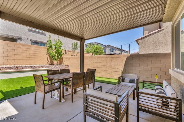 8055 Tank Loop St, Las Vegas, NV 89166 - fenced backyard featuring a patio area, an outdoor hangout area, and outdoor dining space