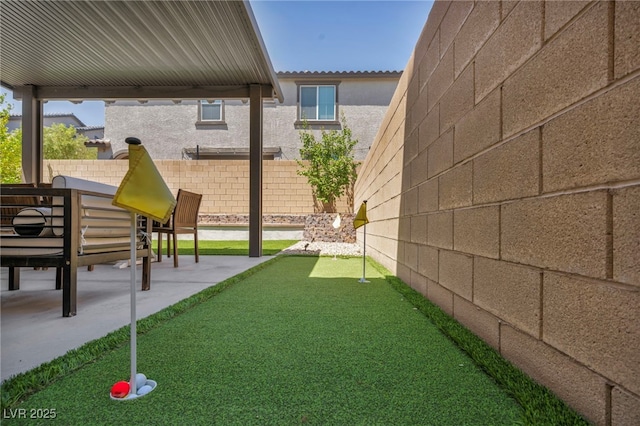 8055 Tank Loop St, Las Vegas, NV 89166 - fenced backyard featuring a putting area and a patio