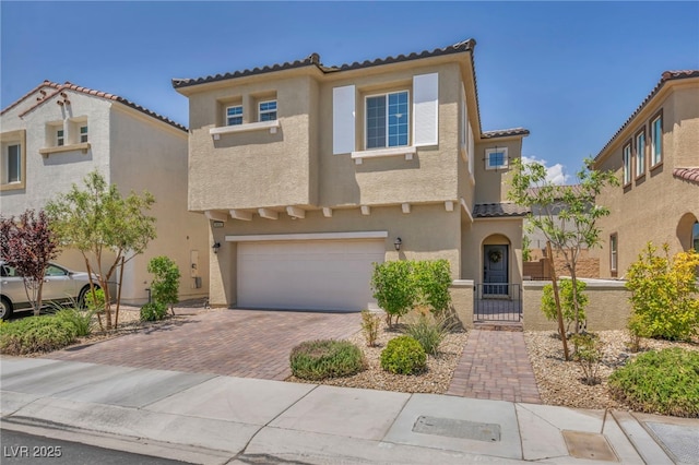 8055 Tank Loop St, Las Vegas, NV 89166 - mediterranean / spanish home with stucco siding, a tile roof, decorative driveway, and an attached garage