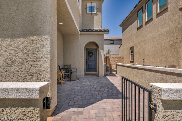 8055 Tank Loop St, Las Vegas, NV 89166 - view of exterior entry featuring stucco siding and a tile roof