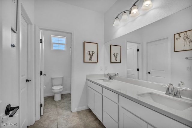 8055 Tank Loop St, Las Vegas, NV 89166 - bathroom with double vanity, toilet, baseboards, and tile patterned floors