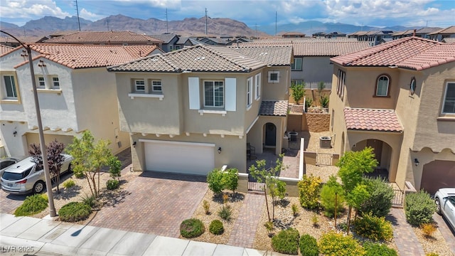 8055 Tank Loop St, Las Vegas, NV 89166 - mediterranean / spanish house featuring a residential view, a mountain view, and stucco siding