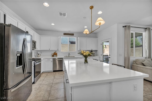 8055 Tank Loop St, Las Vegas, NV 89166 - kitchen featuring stainless steel appliances, a sink, white cabinetry, recessed lighting, and light countertops
