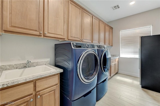 2168 Big Bar Dr, Henderson, NV 89052 - washroom with washing machine and dryer, cabinet space, light wood finished floors, baseboards, and recessed lighting