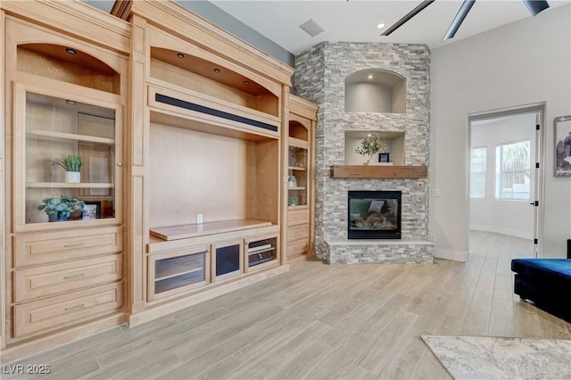 2168 Big Bar Dr, Henderson, NV 89052 - living area featuring light wood-style flooring, a fireplace, built in features, and baseboards
