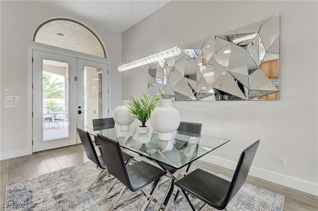 2168 Big Bar Dr, Henderson, NV 89052 - dining room with wood finished floors, french doors, and baseboards