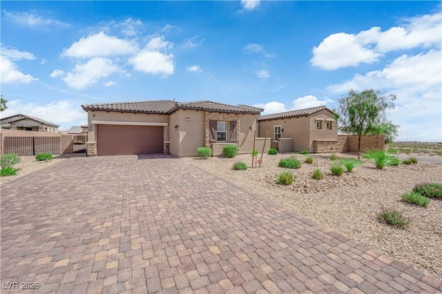 7258 W Le Baron Ave, Las Vegas, NV 89178 - mediterranean / spanish house featuring stucco siding, decorative driveway, a tiled roof, an attached garage, and stone siding