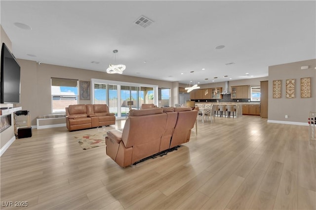 7258 W Le Baron Ave, Las Vegas, NV 89178 - living room featuring light wood-style flooring, a chandelier, baseboards, and recessed lighting