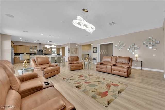 7258 W Le Baron Ave, Las Vegas, NV 89178 - living area with a chandelier, light wood-type flooring, recessed lighting, and baseboards