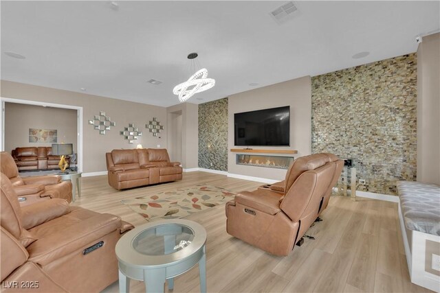 7258 W Le Baron Ave, Las Vegas, NV 89178 - living area with light wood-type flooring, baseboards, and a chandelier