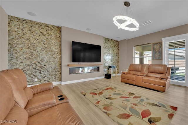 7258 W Le Baron Ave, Las Vegas, NV 89178 - living room featuring a chandelier, healthy amount of natural light, wood finished floors, and baseboards