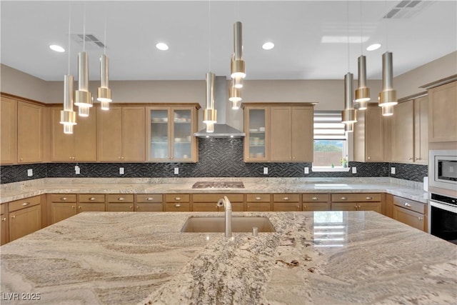 7258 W Le Baron Ave, Las Vegas, NV 89178 - kitchen with a sink, wall chimney range hood, stainless steel microwave, gas cooktop, and light stone counters