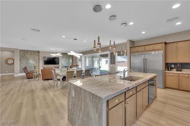 7258 W Le Baron Ave, Las Vegas, NV 89178 - kitchen with a sink, appliances with stainless steel finishes, a kitchen island with sink, light wood-type flooring, and recessed lighting