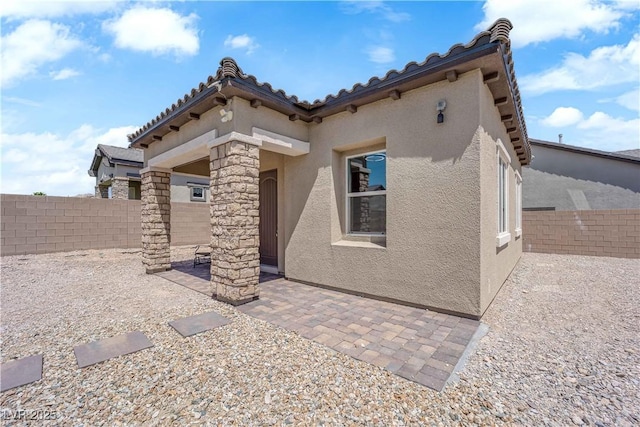 7258 W Le Baron Ave, Las Vegas, NV 89178 - back of house featuring stucco siding, a fenced backyard, a patio, and a tiled roof