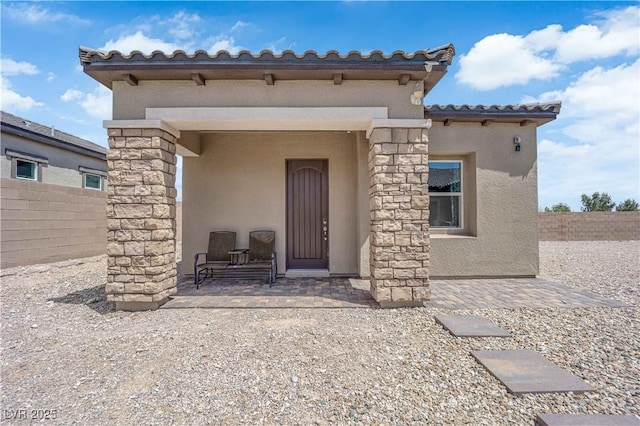 7258 W Le Baron Ave, Las Vegas, NV 89178 - property entrance featuring stucco siding, a tile roof, and stone siding
