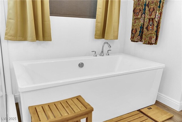 7258 W Le Baron Ave, Las Vegas, NV 89178 - bathroom featuring a freestanding tub and wood finished floors