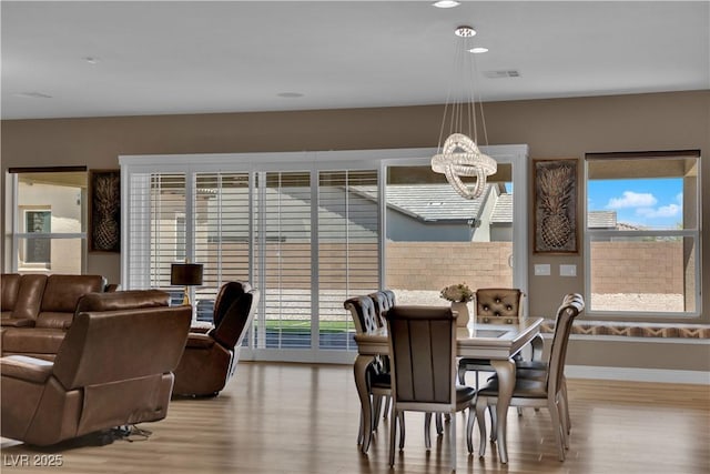 7258 W Le Baron Ave, Las Vegas, NV 89178 - dining room featuring wood finished floors, a chandelier, baseboards, and recessed lighting