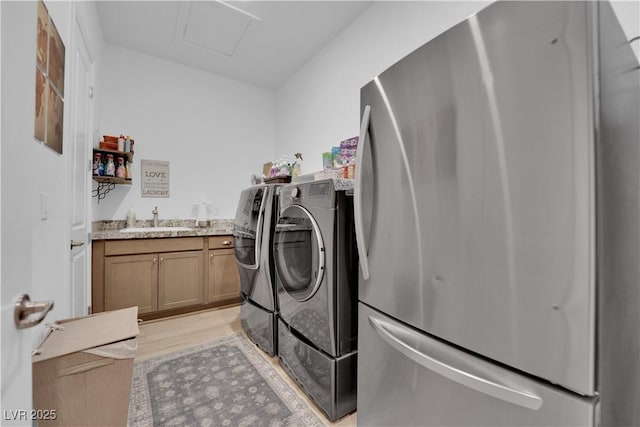 7258 W Le Baron Ave, Las Vegas, NV 89178 - laundry area with washer and clothes dryer, attic access, and light wood finished floors